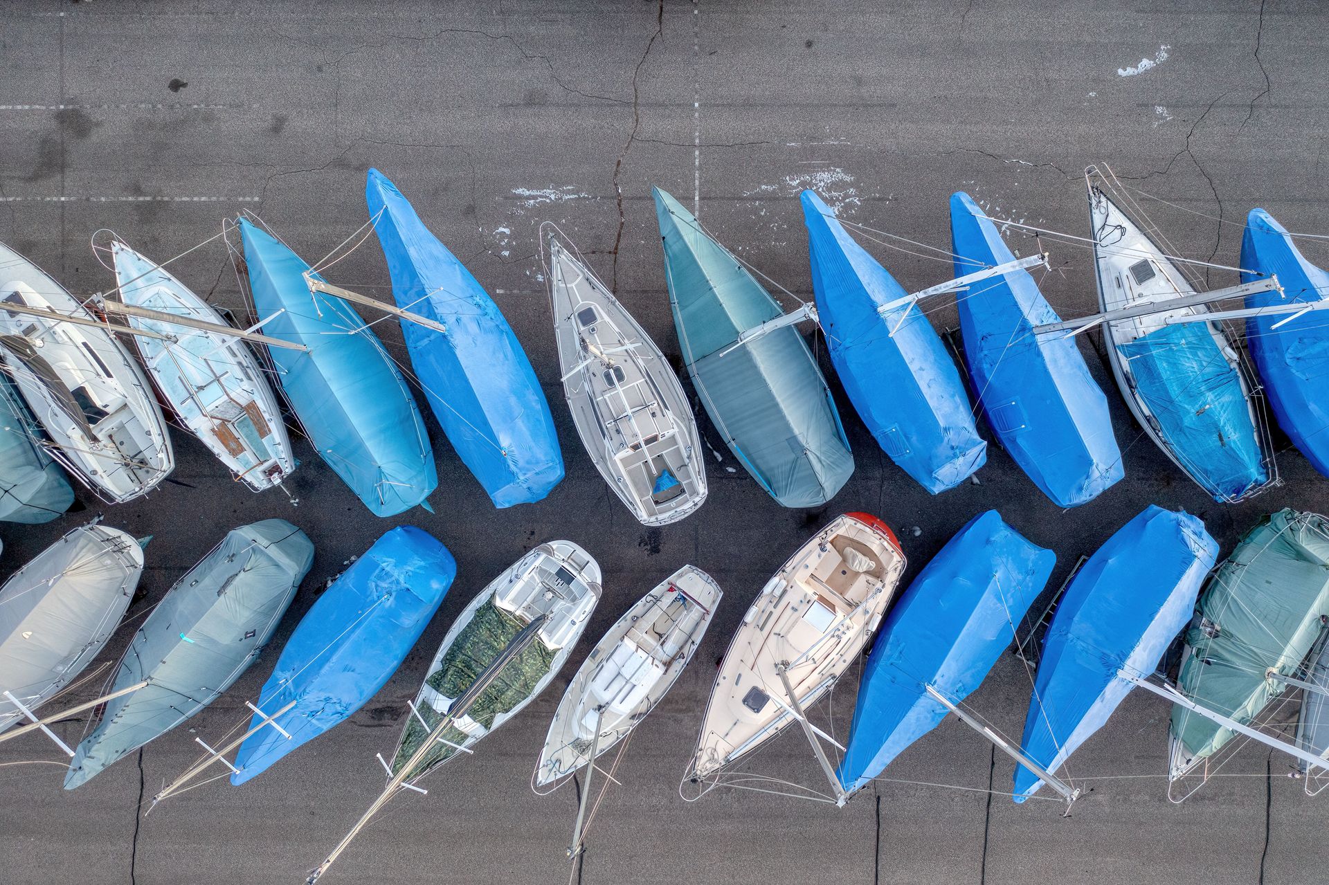 Top-down image of arranged sailboats with blue covers in Lake City, Minnesota.